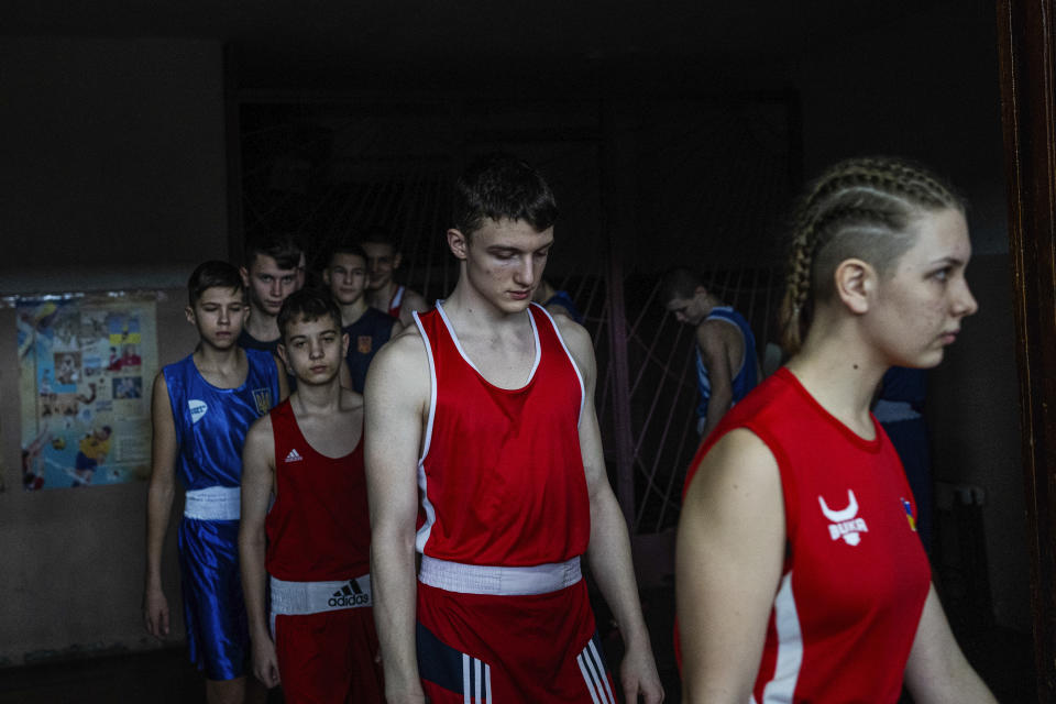 Young boxers enter the opening ceremony of a boxing tournament in honor of Maksym Halinichev, who was killed during fighting with Russian forces in March 2023, in Romny, Sumy region, Ukraine on Sunday, Feb. 3, 2024. (AP Photo/Evgeniy Maloletka)