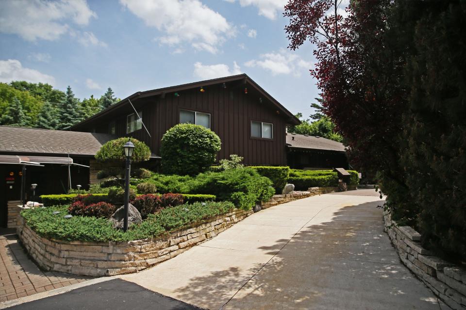 Bud Wiggins created a low-maintenance garden at his Menomonee Falls home, as seen June 15. The former landscaper uses rocks, berms and plants to provide privacy at his home.