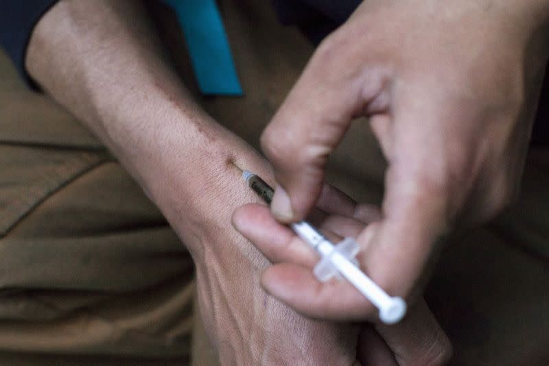 A man injects himself with heroin using a needle obtained from the People's Harm Reduction Alliance, the nation's largest needle-exchange program, in Seattle, Washington