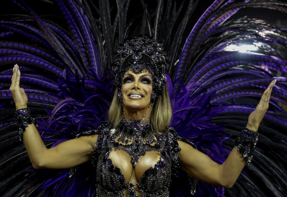 Transgender godmother Camila Prins poses for pictures prior to performing for Colorado do Bras samba school in Sao Paulo, Brazil, Saturday, Feb. 22, 2020. Prins entered Sao Paulo's Carnival parade grounds, in a costume of feathers that displayed her sinuous body, fulfilling a dream nearly three decades old. (AP Photo/Andre Penner)