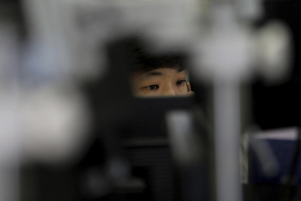 A currency trader watches monitors at the foreign exchange dealing room of the KEB Hana Bank headquarters in Seoul, South Korea, Thursday, Oct. 17, 2019. Asian shares were mixed Thursday after officials signaled work remains to be done on an agreement for a truce in the tariff war between the U.S. and China. (AP Photo/Ahn Young-joon)