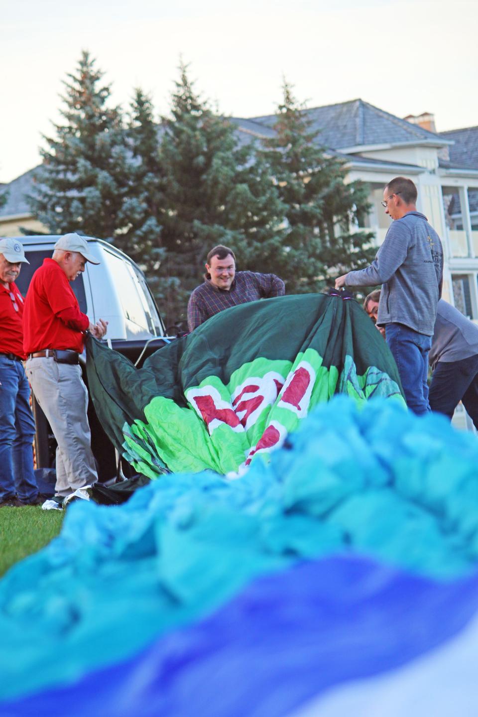 Hot air balloon pilots and crew work on putting up one of their hot air balloons for a quick demonstration during a previous Balloons over Bay Harbor event. All balloon flights are dependent on weather.