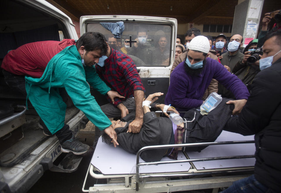 A Kashmiri man injured in an attack is brought for treatment at a hospital in Srinagar, Indian controlled Kashmir, Monday, March. 29, 2021. Gunmen killed an elected official of India’s ruling party and a policeman in disputed Kashmir on Monday, police said. (AP Photo/Mukhtar Khan)