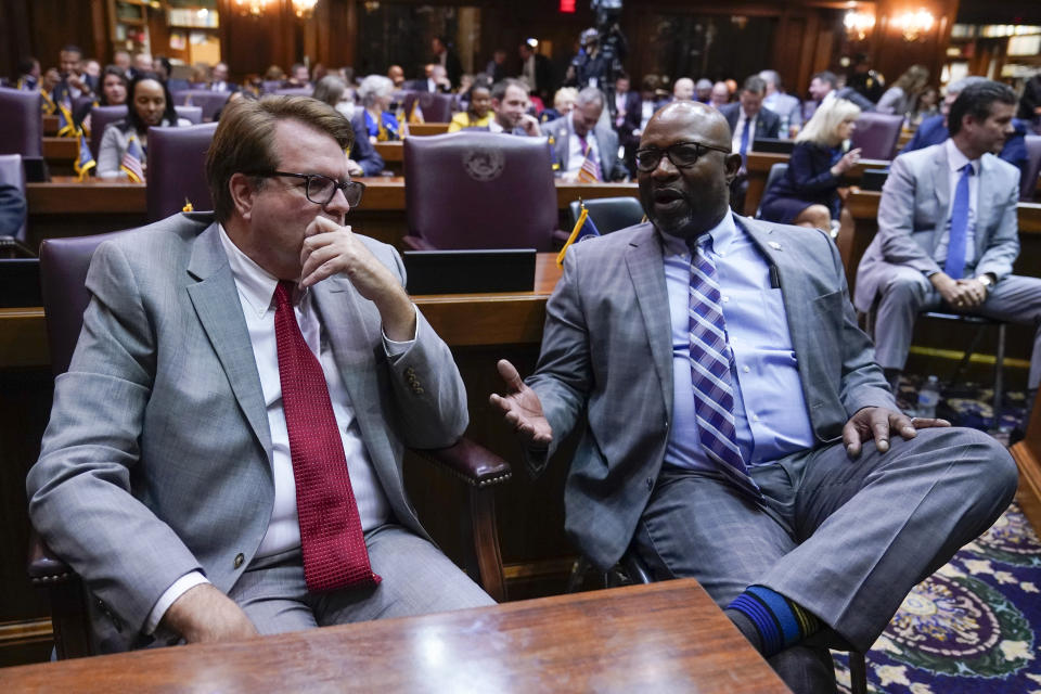 Indiana House Minority Leader Phil GiaQuinta, left, D-Fort Wayne, talks with Sen. Greg Taylor before Gov. Eric Holcomb delivers his State of the State address to a joint session of the legislature at the Statehouse, Tuesday, Jan. 10, 2023, in Indianapolis. (AP Photo/Darron Cummings)