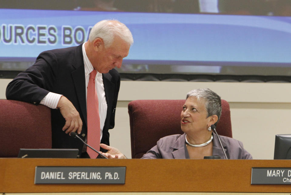 California Air Resources Board Member Ron Roberts talks with ARB chair Mary Nichols during a hearing held Thursday, Sept. 20, 2012, in Sacramento, Calif. The board took testimony from experts and the public on the the cost to businesses and consumers with the implementation of AB32, California's landmark greenhouse gas emissions law. (AP Photo/Rich Pedroncelli)