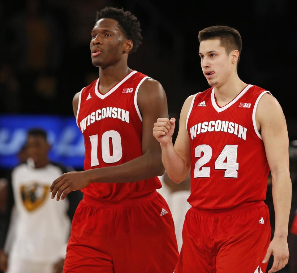 FILE- In this Nov. 22, 2015, file photo, Wisconsin guard Bronson Koenig (24) and forward Nigel Hayes (10) walk off the court after Wisconsin defeated VCU 74-73 in an NCAA college basketball game for third place in the 2K Classic in New York. Seniors Hayes and Koenig are getting one last shot to make an NCAA Tournament run. They have had accomplished careers, having played key roles on two Final Four teams. (AP Photo/Kathy Willens, File)