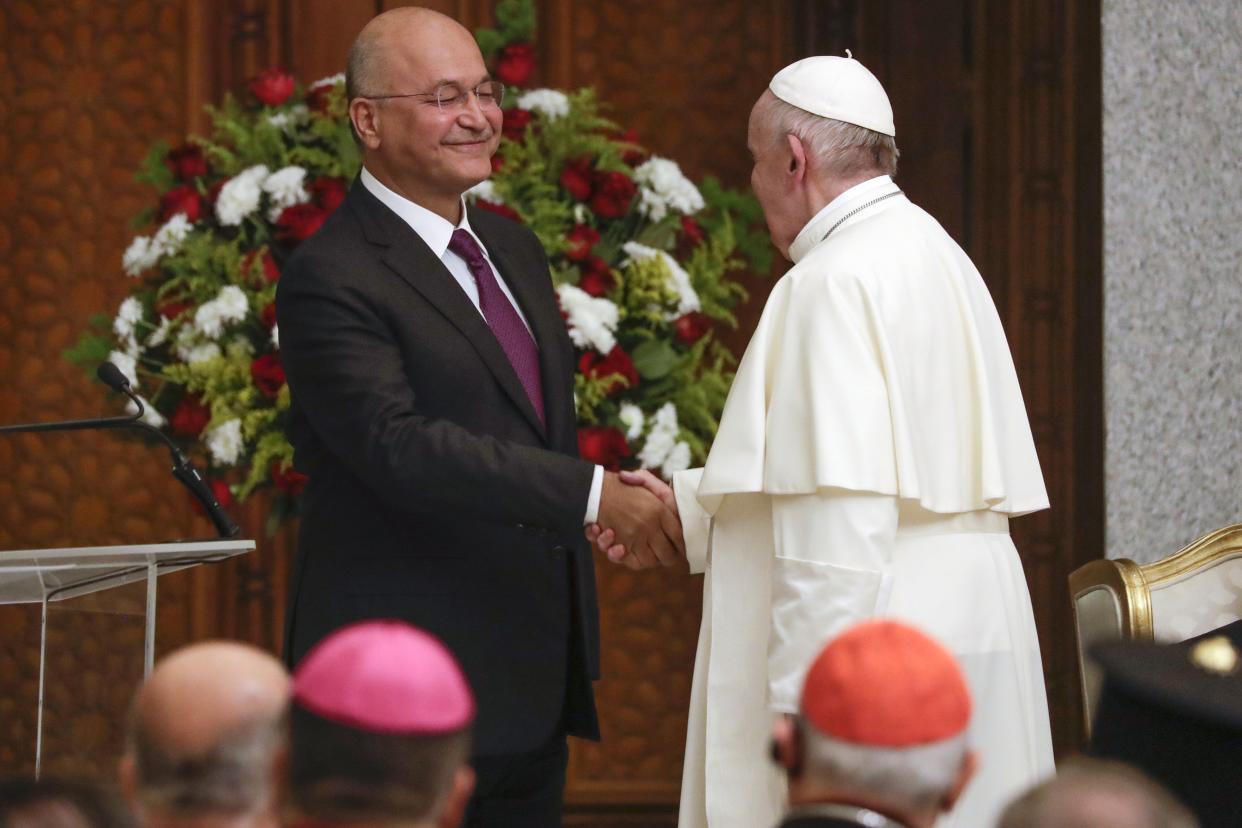 Pope Francis and Iraqi President Barham Salih shake hands, at Baghdad's Presidential Palace, Iraq, Friday, March 5. 