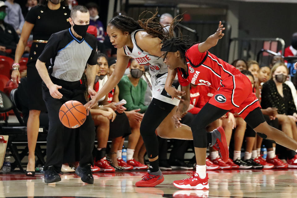 North Carolina State's Kayla Jones (25) takes the ball away from Georgia's Que Morrison (23) during the second half of an NCAA college basketball game, Thursday, Dec. 16, 2021, in Raleigh, N.C. (AP Photo/Karl B. DeBlaker)