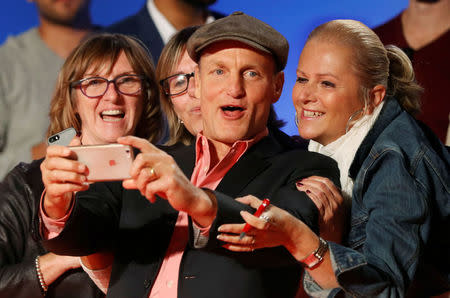 Actor Woody Harrelson greets fans as he arrives on the red carpet for the film LBJ. REUTERS/Mark Blinch