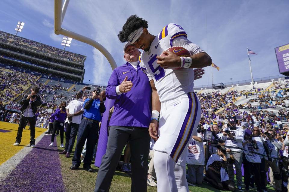 LSU head coach Brian Kelly greets LSU quarterback Jayden Daniels (5) as the school honors senior players on senior day, before an NCAA college football game against Texas A&M in Baton Rouge, La., Saturday, Nov. 25, 2023. (AP Photo/Gerald Herbert)