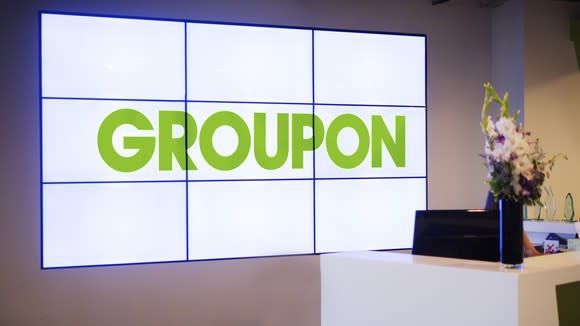 Nine projection TVs spelling out Groupon at the company's HQ.