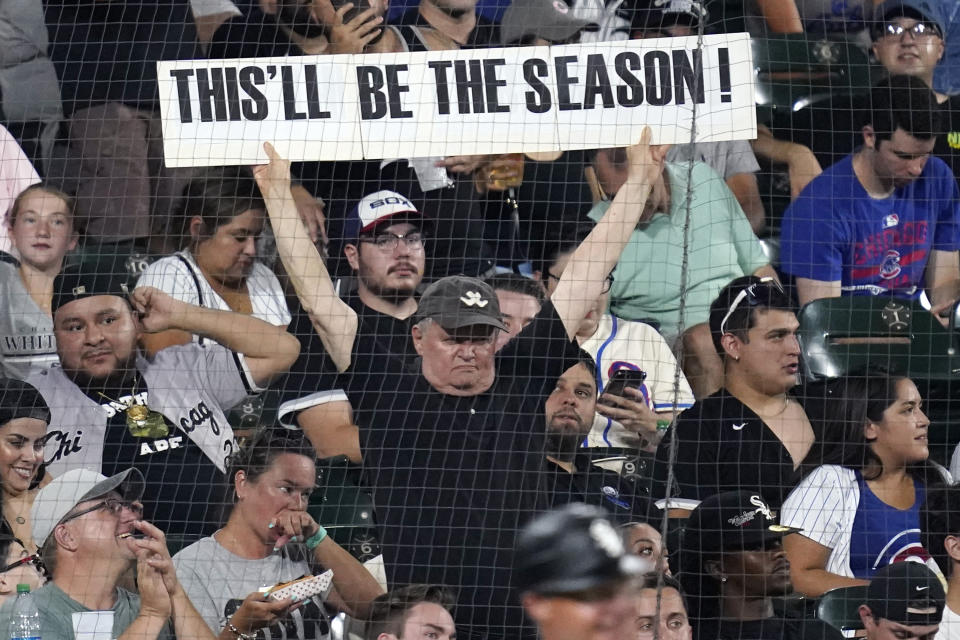 A spectator holds a sign during the fifth inning of the team's baseball game against the Chicago Cubs on Friday, Aug. 27, 2021, in Chicago. (AP Photo/Nam Y. Huh)