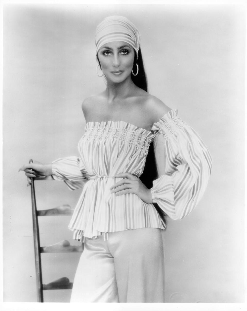 <p>In a matching bandana and off-the-shoulder top for a portrait session in 1976. </p>