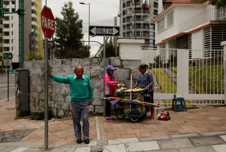 Street vendor stands near the Electoral National Council (CNE) headquarters prior to Sunday presidential election in Quito, Ecuador, April 1, 2017. REUTERS/Mariana Bazo