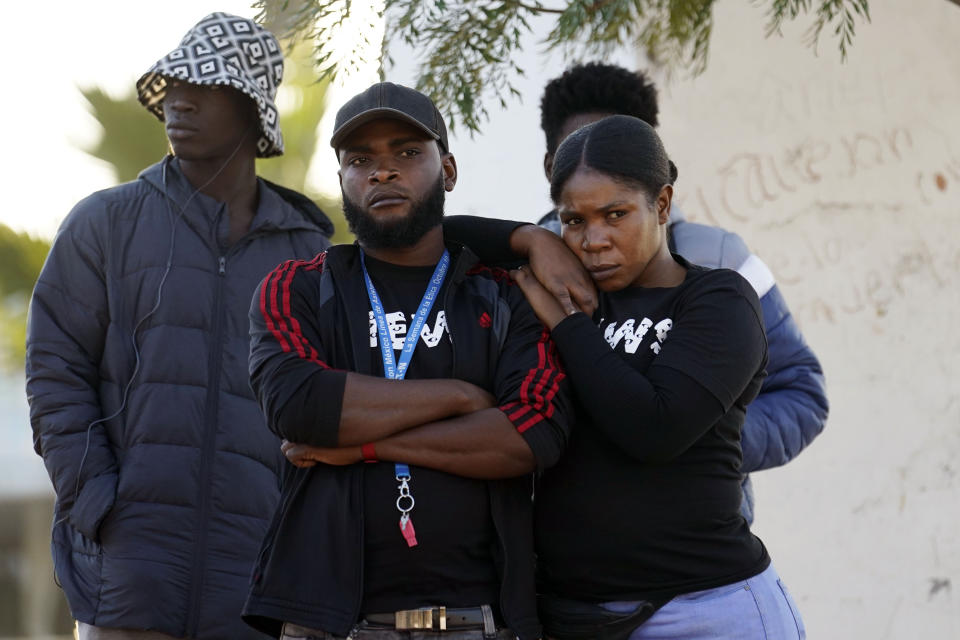 Haitian migrants listen to immigration attorneys giving updates on their current asylum status Tuesday, Dec. 20, 2022, in Tijuana, Mexico. The U.S. government made its plea in a filing a day after Chief Justice John Roberts issued a temporary order to keep the pandemic-era limits on migrants in place. (AP Photo/Marcio Jose Sanchez)