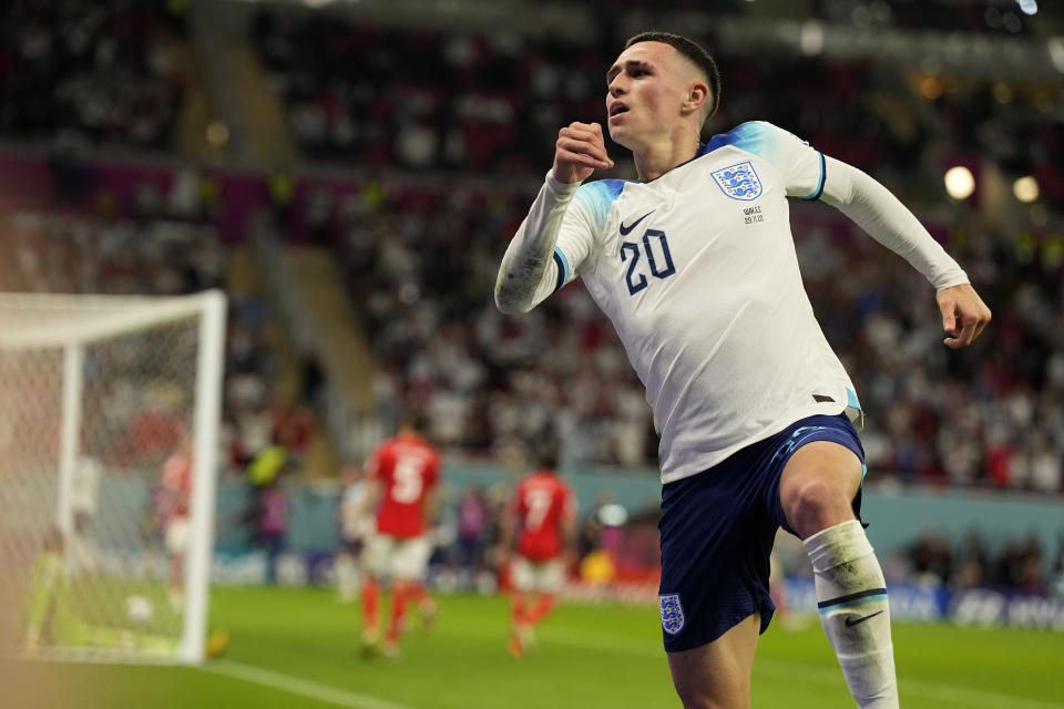 England's Phil Foden celebrates after scoring his side's second goal during the World Cup group B soccer match between England and Wales, at the Ahmad Bin Ali Stadium in Al Rayyan, Qatar, Tuesday, Nov. 29, 2022. (AP Photo/Pavel Golovkin)