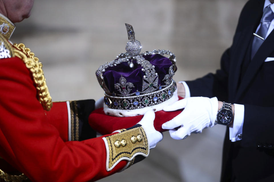 The crown of Britain's Queen Elizabeth II is carried to the official State Opening of Parliament in London, Monday Oct. 14, 2019. (Hannah McKay/Pool via AP)