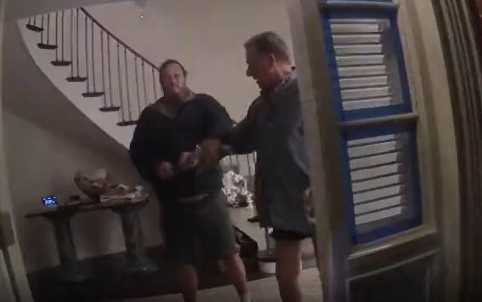 David DePape, left, and Paul Pelosi are seen struggling over a hammer at Pelosi's residence in San Francisco, October 28, 2022, in this screengrab from police bodycam video. / Credit: San Francisco Superior Court