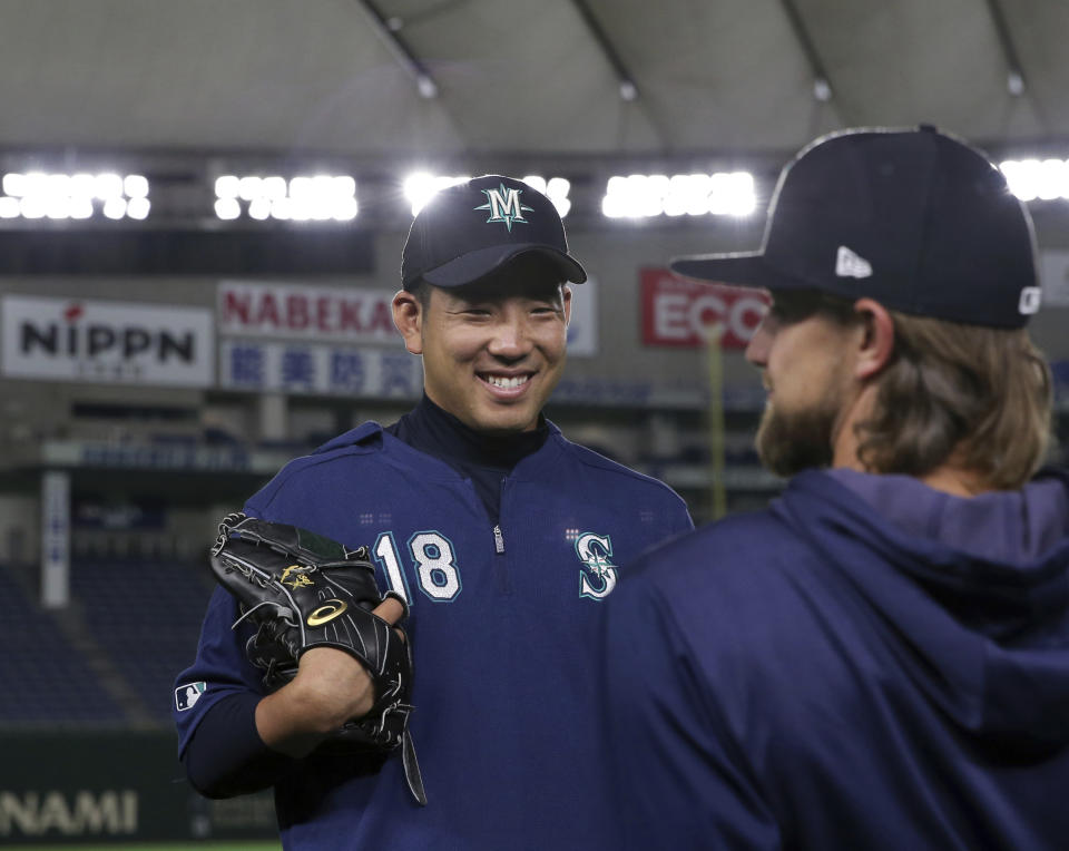 Seattle Mariners pitcher Yusei Kikuchi smiles with his teammate during his team's practice at Tokyo Dome in Tokyo, Saturday, March 16, 2019. Just as he was adjusting to life in the United States, Kikuchi is back in Japan getting ready to make his Major League pitching debut in front of a sellout crowd at Tokyo Dome. Kikuchi will be on the mound in Game 2 of the MarinersÅf season-opening series in Japan. (AP Photo/Toru Takahashi)