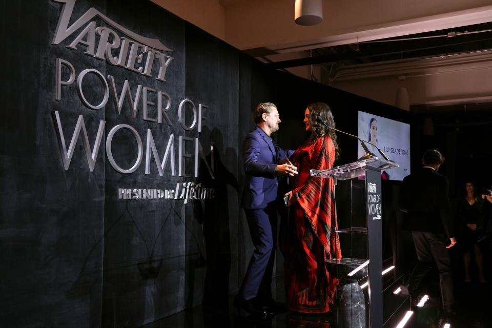 Honoree Lily Gladstone, right, accepts an award on Nov. 16 from her "Killers of the Flower Moon" co-star Leonardo DiCaprio onstage during Variety Power of Women Los Angeles presented by Lifetime at Mother Wolf in Los Angeles, California.