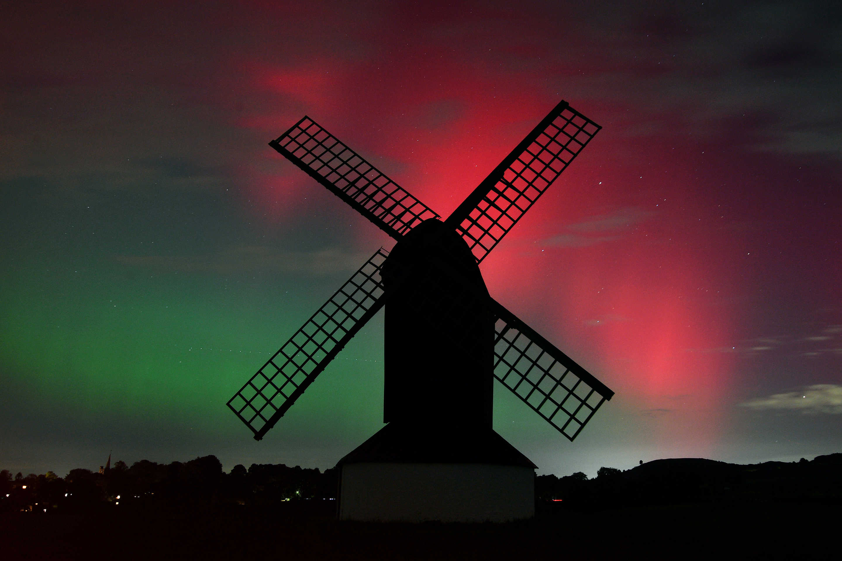 The aurora borealis light up the night sky over Pitstone Windmill in Buckinghamshire, Pitstone, United Kingdom, on Thursday. (Jim Dyson/Getty Images)