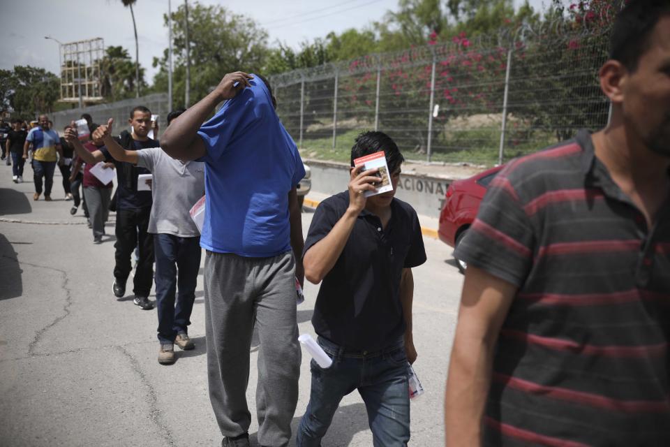 FILE - In this July 31, 2019, file photo, migrants return to Mexico, using the Puerta Mexico bridge that crosses the Rio Grande river in Matamoros, Mexico, on the border with Brownsville, Texas. A federal judge on Tuesday, Jan. 26, 2021, barred the U.S. government from enforcing a 100-day deportation moratorium that is a key immigration priority of President Joe Biden. U.S. District Judge Drew Tipton issued a temporary restraining order sought by Texas, which sued on Friday against a Department of Homeland Security memo that instructed immigration agencies to pause most deportations. Tipton said the Biden administration had failed “to provide any concrete, reasonable justification for a 100-day pause on deportations.” (AP Photo/Emilio Espejel, File)