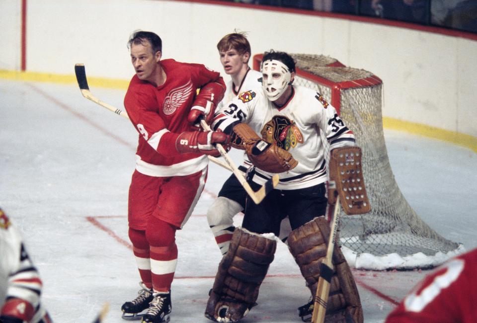 Chicago Blackhawks goalie Tony Esposito (35) and defender Keith Magnuson (3) in action against Detroit Red Wings right wing Gordie Howe (9) during the 1970 season.