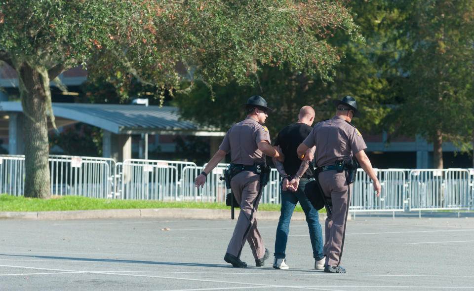 Police escorted him off campus in handcuffs.&nbsp;