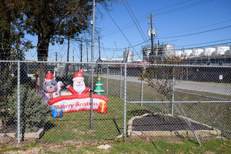 Christmas decorations are displayed behind a barbed-wire fence at K-Solv's office in Channelview's Jacintoport neighborhood.