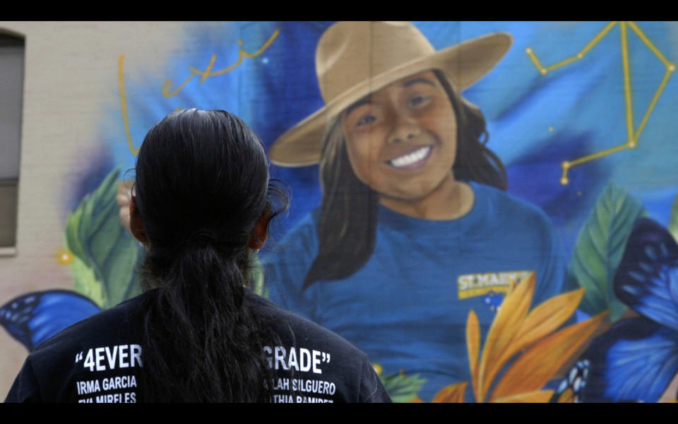 Kim Rubio looking at a mural depicting her daughter.