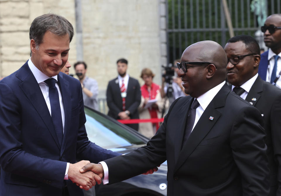 Belgium's Prime Minister Alexander De Croo, left, greets Democratic Republic of the Congo Prime Minister Jean-Michel Sama Lukonde as he arrives for a ceremony at the Egmont Palace in Brussels, Monday, June 20, 2022. On Monday, more than sixty one years after his death, the mortal remains of Congo's first democratically elected prime minister Patrice Lumumba will be handed over to his children during an official ceremony in Belgium. (AP Photo/Olivier Matthys, Pool)