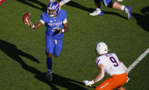 Air Force quarterback Haaziq Daniels, left, pitches the ball as Boise State linebacker Brock Miller defends during the first half of an NCAA college football game Saturday Oct. 31, 2020, at Air Force Academy, Colo. (AP Photo/David Zalubowski)