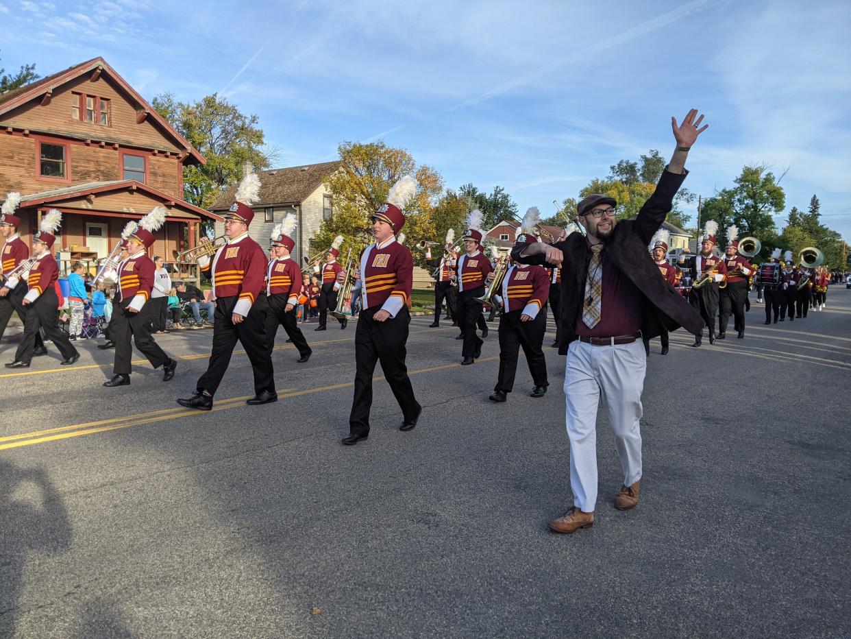 Travis Netzer, lecturer of euphonium and tuba at Northern State University, greets the crowd at the onset of the 2021 homecoming parade on Main Street.