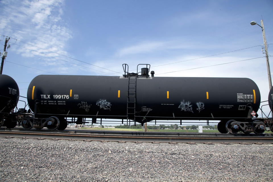 In this Aug. 8, 2012 photo, a DOT-111 rail tanker passes through Council Bluffs, Iowa. DOT-111 rail cars being used to ship crude oil from North Dakota's Bakken region are an "unacceptable public risk," and even cars voluntarily upgraded by the industry may not be sufficient, a member of the National Transportation Safety Board said Wednesday, Feb. 16, 2014. The cars were involved in derailments of oil trains in Casselton, N.D., and Lac-Megantic, Quebec, just across the U.S. border, NTSB member Robert Sumwalt said at a House Transportation subcommittee hearing. (AP Photo/Nati Harnik, File)