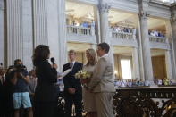 FILE - In this June 28, 2013, file photo Sandy Stier, center left, and Kris Perry, at right, exchange wedding vows in front of California Attorney General Kamala Harris, left, at City Hall in San Francisco. Stier and Perry, the lead plaintiffs in the U.S. Supreme Court case that overturned California's same-sex marriage ban, tied the knot about an hour after a federal appeals court freed same-sex couples to obtain marriage licenses for the first time in 4 1/2 years. (AP Photo/Marcio Jose Sanchez, File)