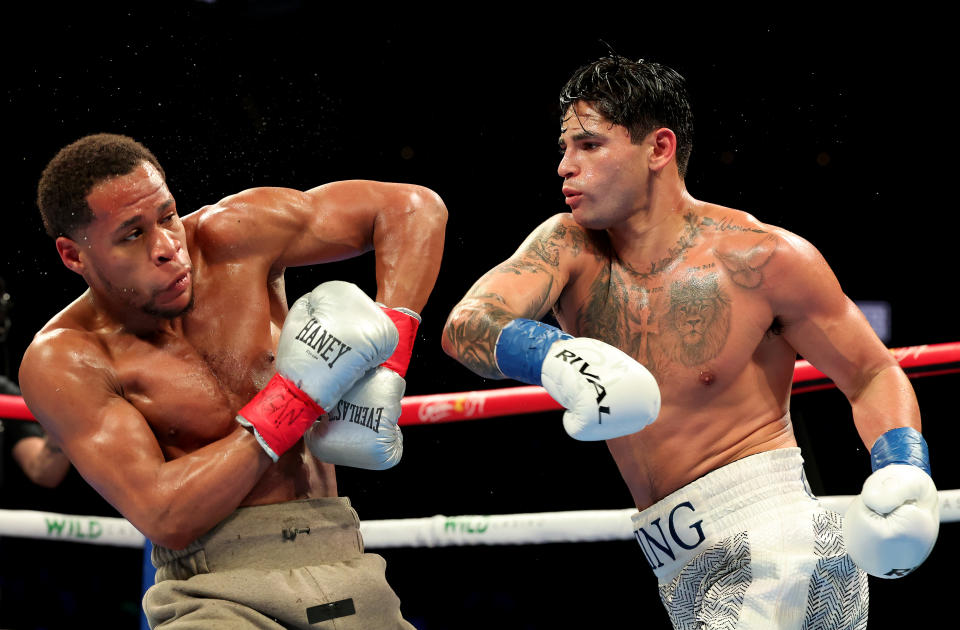 NEW YORK, NEW YORK - APRIL 20: Ryan Garcia (white trunks) punches Devin Haney (gray trunks) during their WBC Super Lightweight title bout at Barclays Center on April 20, 2024 in New York City.  (Photo by Al Bello/Getty Images)