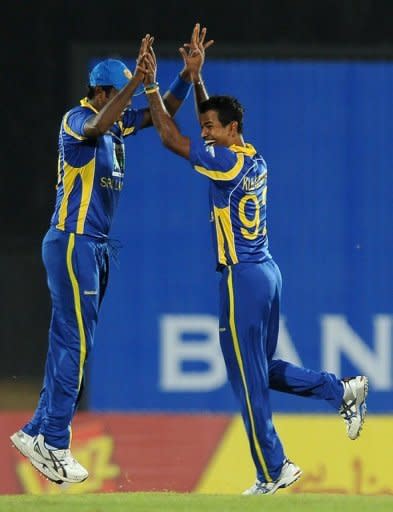 Sri Lankan cricketer Nuwan Kulasekera (R) celebrates with his teammate Angelo Mathews after he dismissed Pakistan Twenty20 cricket captain Mohammad Hafeez. Sri Lanka put on a brilliant bowling and fielding performance to post a comfortable 37-run victory over Pakistan in their opening Twenty20 international