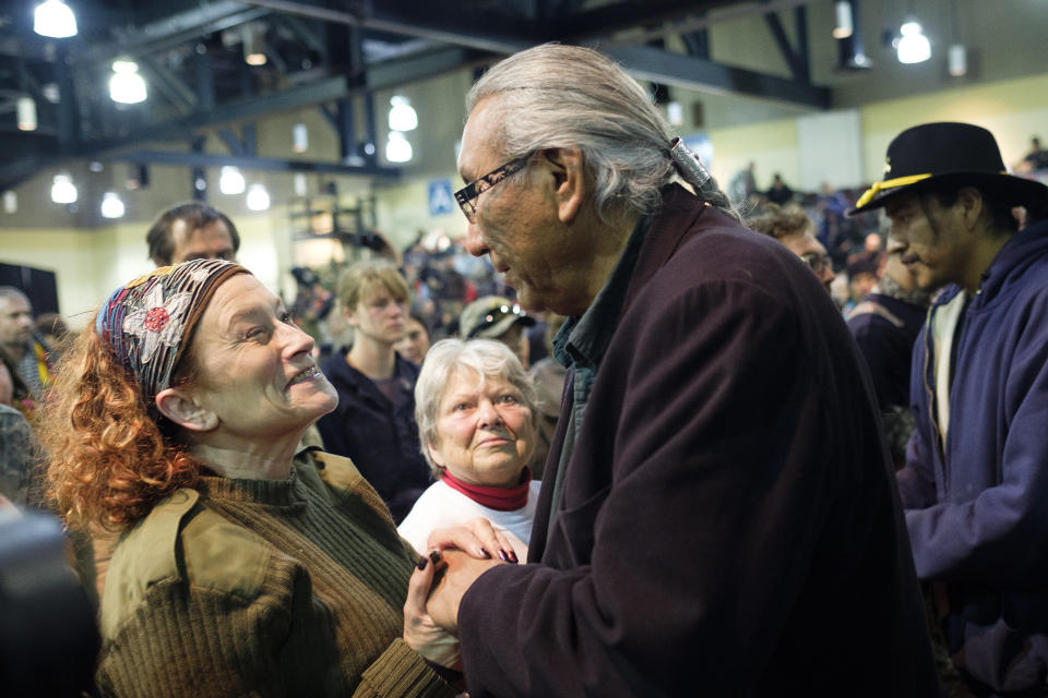 U.S. Air Force veteran Virginia McIntyre, left, shakes hands with chief Arvol Looking Horse during a forgiveness ceremony for veterans at the Four Prairie Knights Casino &amp; Resort on the Standing Rock Sioux Reservation on Monday.