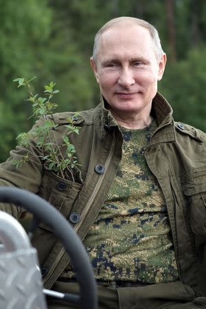 Russian President Vladimir Putin poses for a photo during the hunting and fishing trip which took place on August 1-3 in the republic of Tyva in southern Siberia, Russia, in this photo released by the Kremlin on August 5, 2017. Sputnik/Alexei Nikolsky/Kremlin via REUTERS