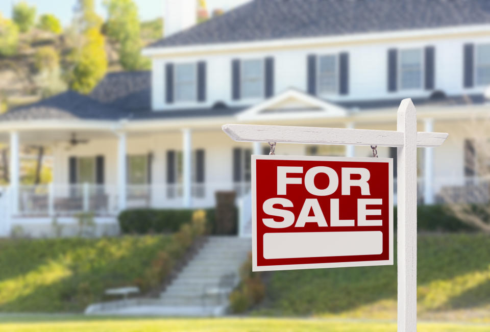 a "for sale" sign in front of a house