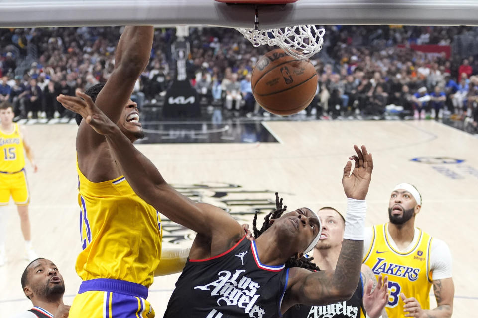 Los Angeles Lakers forward Rui Hachimura, second from left, dunks as Los Angeles Clippers guard Terance Mann, center, defends while Clippers center Daniel Theis, second from right, and Lakers forward Anthony Davis watch during the first half of an NBA basketball game Wednesday, Feb. 28, 2024, in Los Angeles. (AP Photo/Mark J. Terrill)