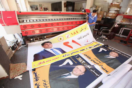 A worker prints campaign posters of candidates ahead of the parliamentary election, in Erbil, Iraq April 15, 2018. Picture taken April 15, 2018. REUTERS/Azad Lashkari