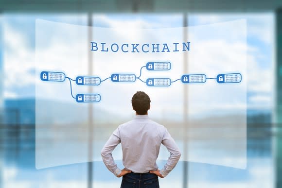 Man staring at blockchain diagram