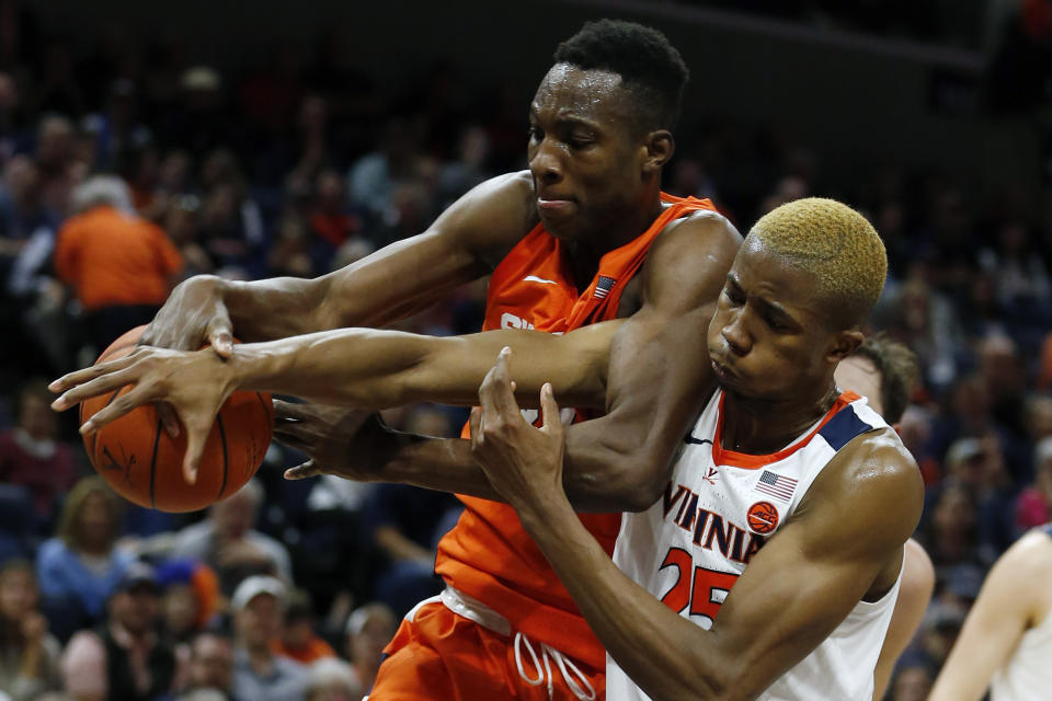 Syracuse forward Bourama Sidibe (34) and Virginia forward Mamadi Diakite (25) battle for a rebound during the first half of an NCAA college basketball game in Charlottesville, Va., Saturday, Jan. 11, 2020. (AP Photo/Steve Helber)