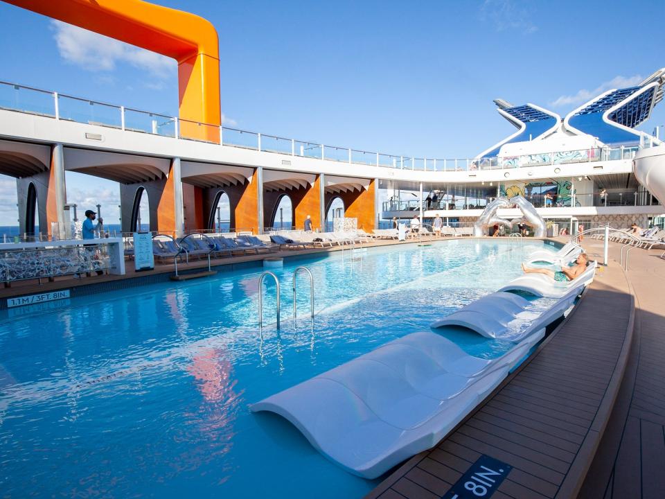 the lounge chairs in a relatively empty pool.