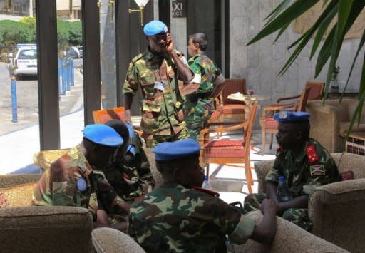 Members of the UN Supervision Mission in Syria (UNSMIS) gather in the lobby of their hotel in Damascus. UN-Arab envoy Kofi Annan expressed "horror" at the Houla massacre of more than 100 people as he began a visit on Monday to the Syrian capital aimed at salvaging his battered peace plan