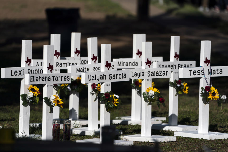 FILE - Crosses with the names of shooting victims are placed outside Robb Elementary School in Uvalde, Texas, May 26, 2022. A federal lawsuit was filed Wednesday, Sept. 28, 2022, in Del Rio, Texas, against eight entities and three individuals for the May shooting that killed 19 students and two teachers at the elementary school. (AP Photo/Jae C. Hong, File)