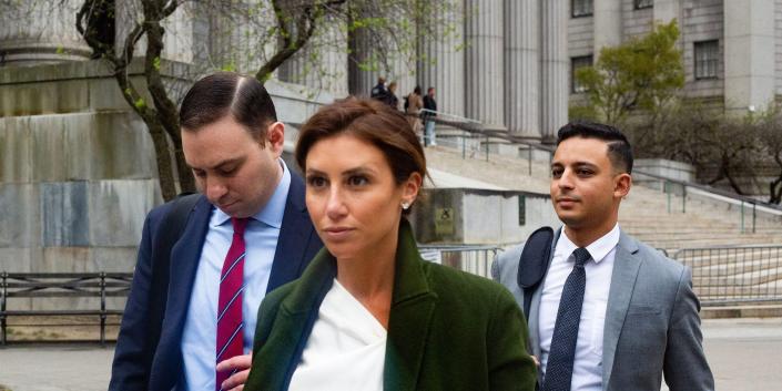 Lawyer Alina Habba, center, with two men, leaving Manhattan Supreme Court on April 25, 2022,