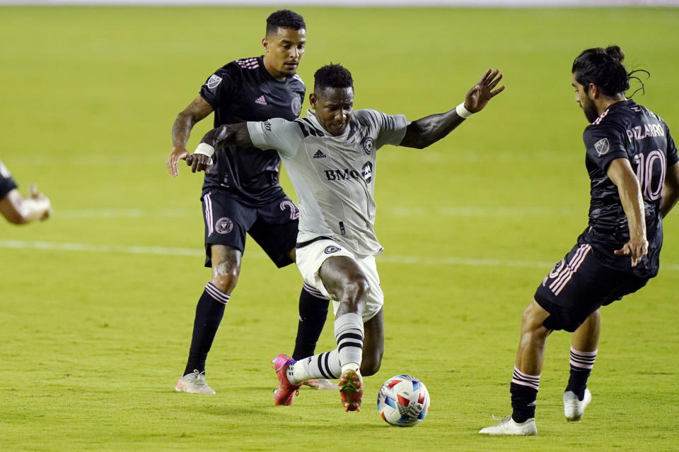 Montreal forward Romell Quioto, center, controls the ball as Inter Miami midfielder Gregore, left, and midfielder Rodolfo Pizarro (10) defend during the first half of an MLS soccer match Wednesday, May 12, 2021, in Fort Lauderdale, Fla. (AP Photo/Lynne Sladky)