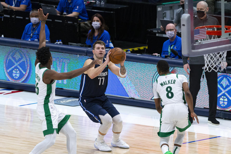 Dallas Mavericks guard Luka Doncic (77) shoots as Boston Celtics forward Aaron Nesmith (26) attempts to defend during the second half of an NBA basketball game in Dallas, Tuesday, Feb. 23, 2021. (AP Photo/Sam Hodde)